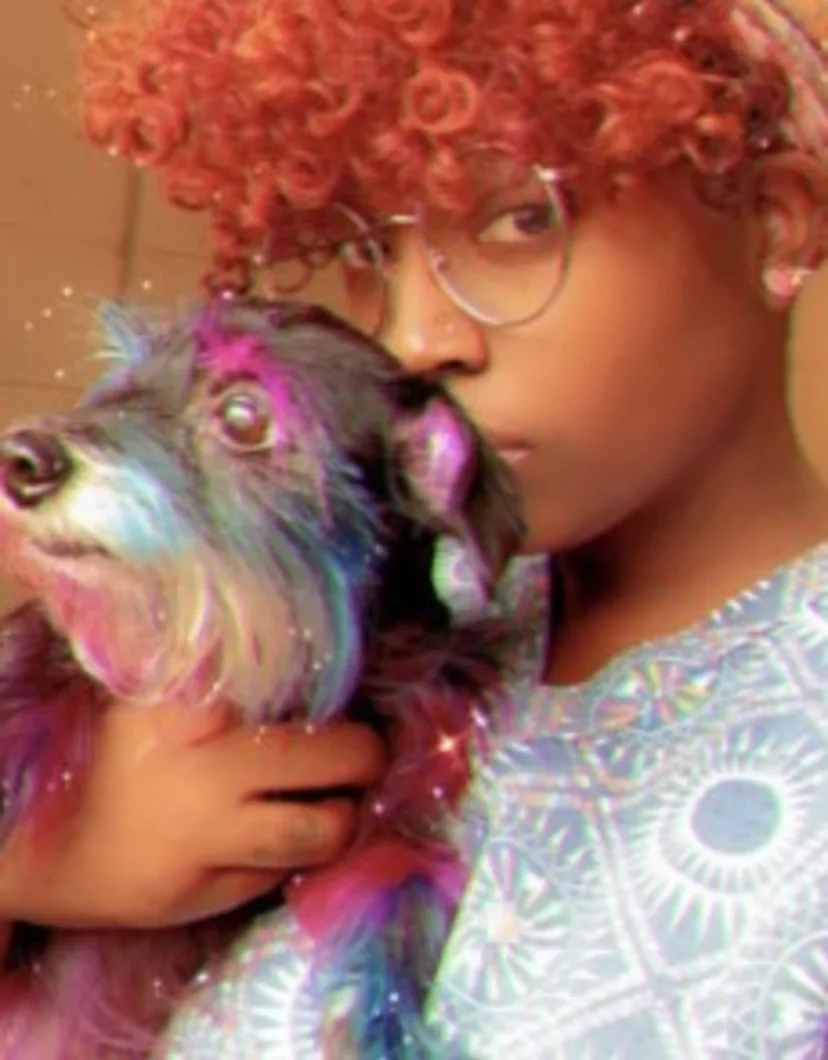 Erika, holding a dog with colorful hair